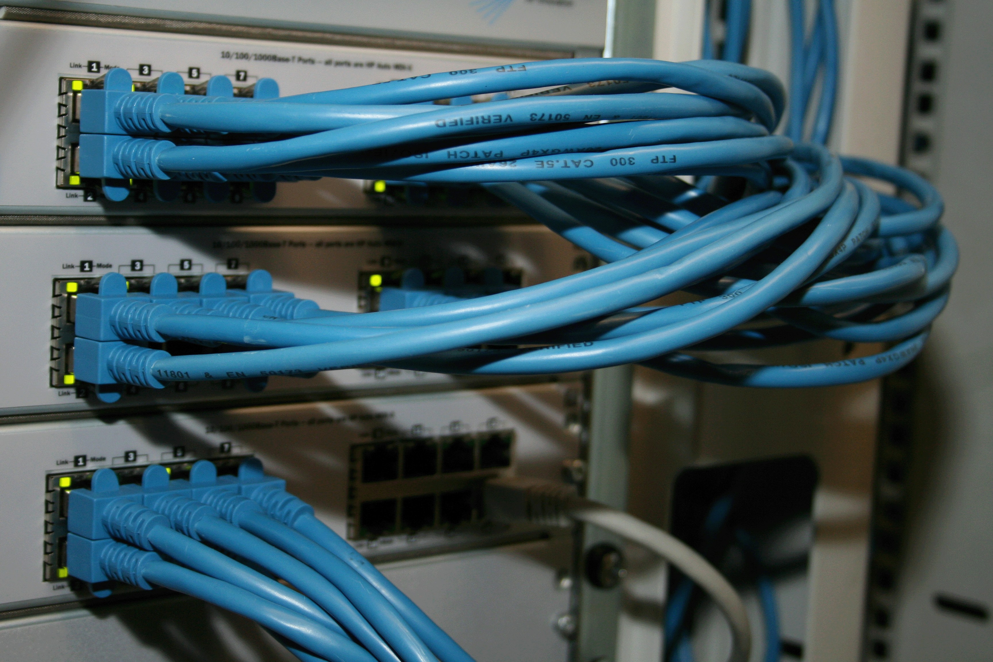 A network switch with ethernet cables plugged into its ports